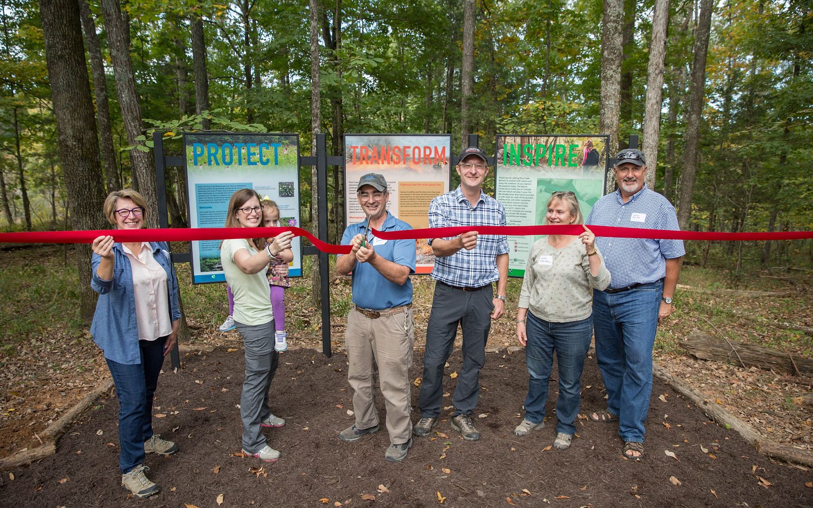 Ribbon Cutting.  TNC's Kentucky state director, David Phemister, and the Steinbock family cut the ribbon to officially open the Pine Creek Barrens Nature Preserve.  © Mike Wilkinson