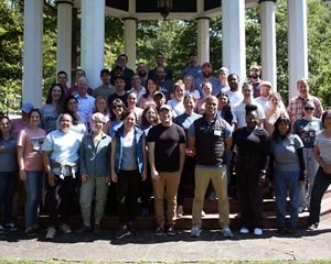Group photo of TNC MD/DC staff. A large group of people stand together outdoors, smiling during the chapter's annual staff retreat.