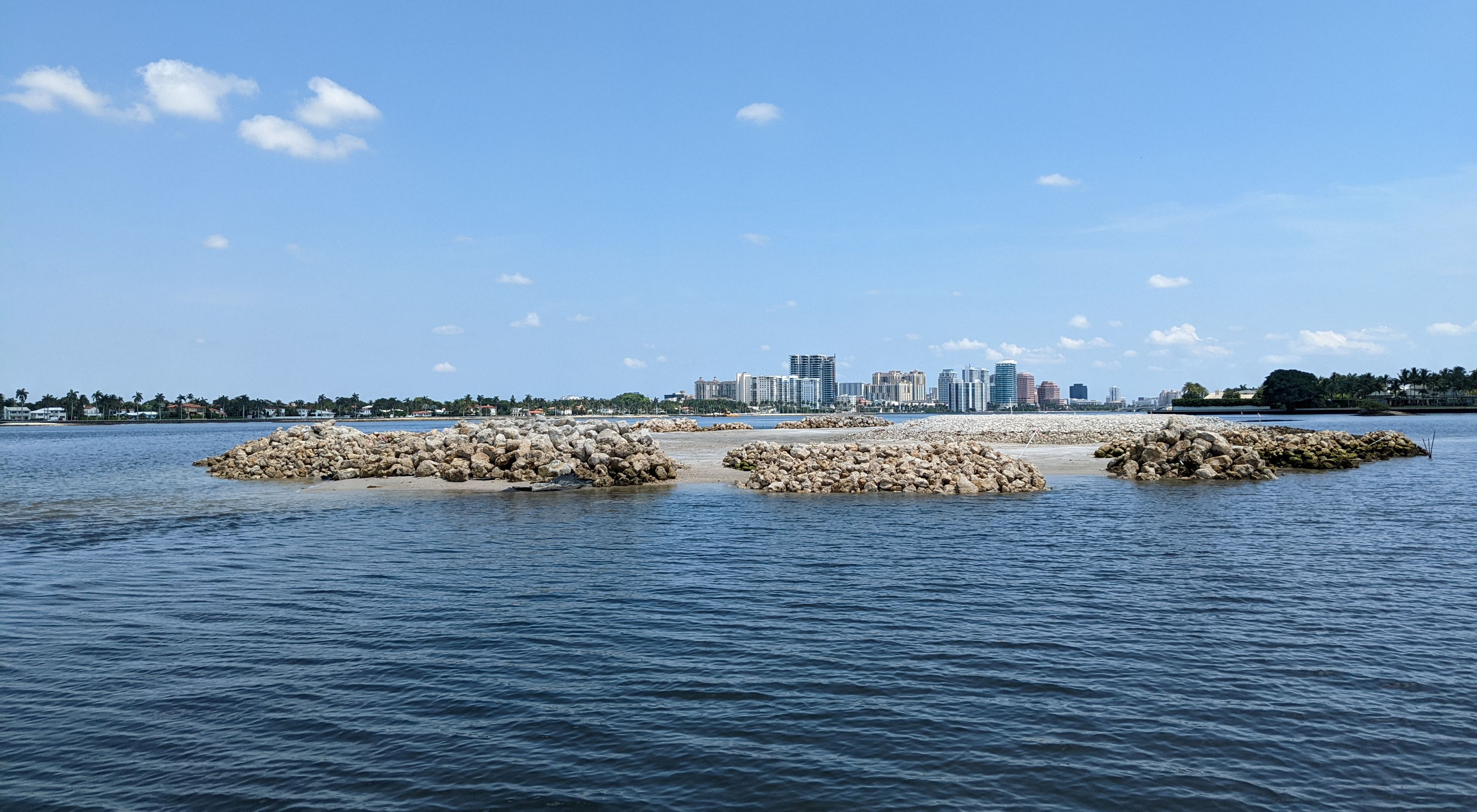 A view through Lake Worth Lagoon looking over the Palm Beach Resilient Island and to the skyline of West Palm Beach on the other side of the lagoon.