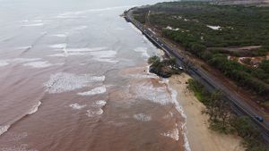 Aerial image of a coastline with brown water.