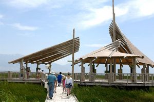 People walk down the path the Great Salt Lake pavilion. 