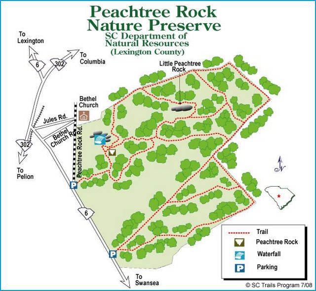 A trail map of a preserve includes red lines to reveal trails and green blobs to identify nature.