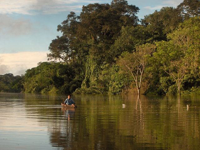 A young boy paddles his dugout canoe to school on the Yarapa River, a tributary of the Amazon in northeastern Peru.