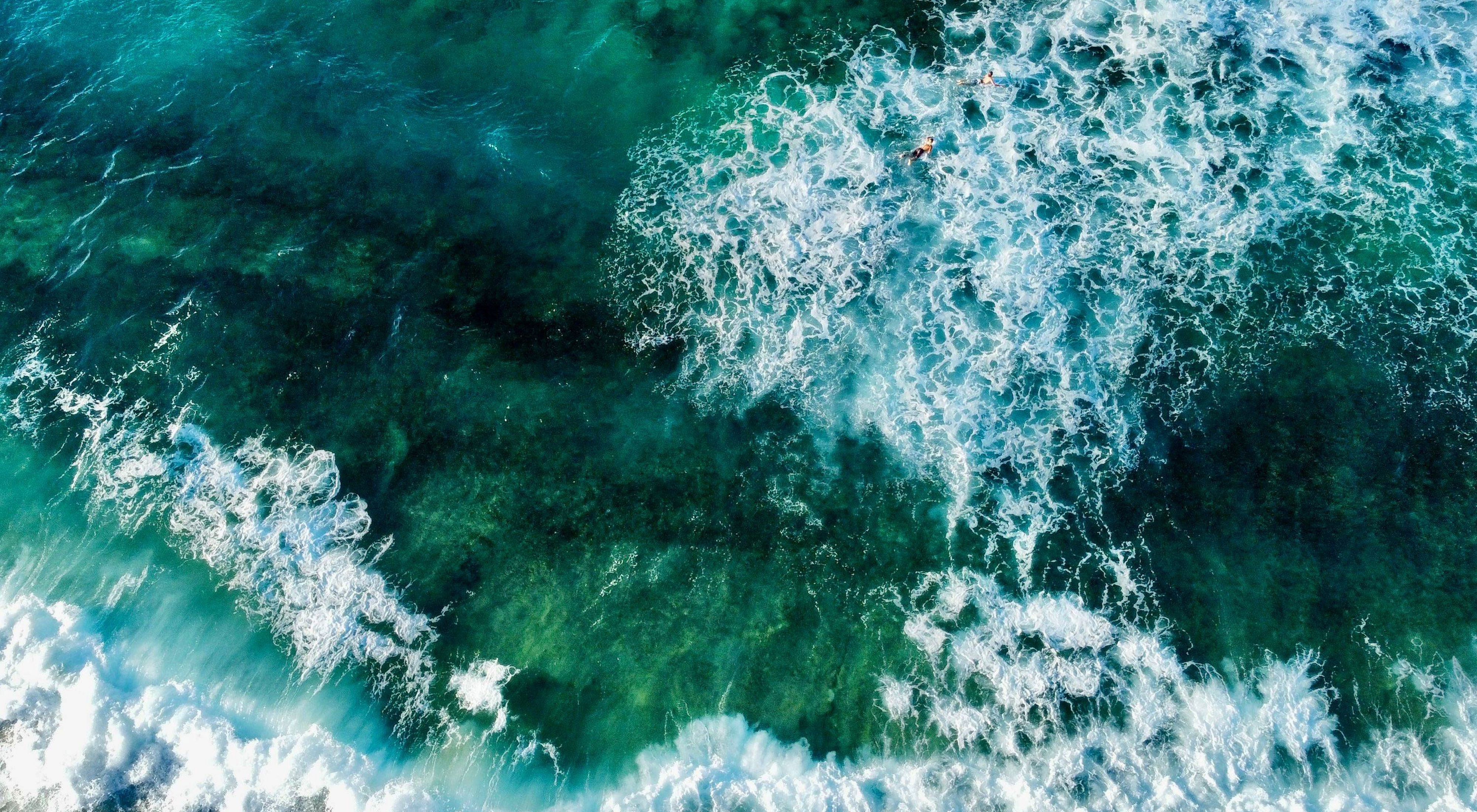 Aerial view looking straight down on green waves in the ocean around Puerto Rico.