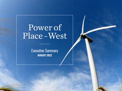A single white windmill against a blue sky, with the words "Power of Place West."