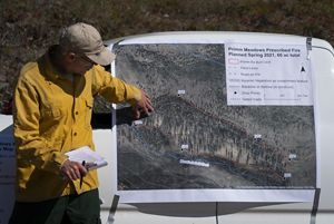 A burn boss explains the burn area on a map of the area prior to a prescribed burn. 