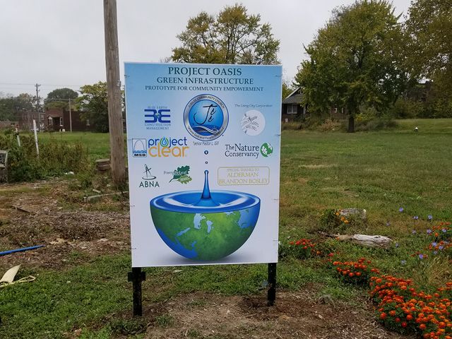 A large sign listing multiple partners of the project.