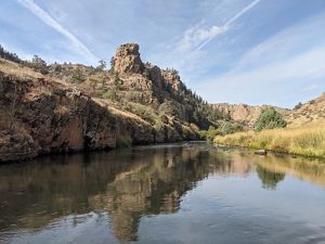 A wide river is flowing between a canyon.