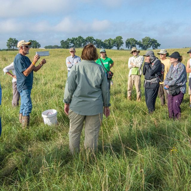 Participants listen to a local ecologist during a Platte River Prairies Field Day hike session. 