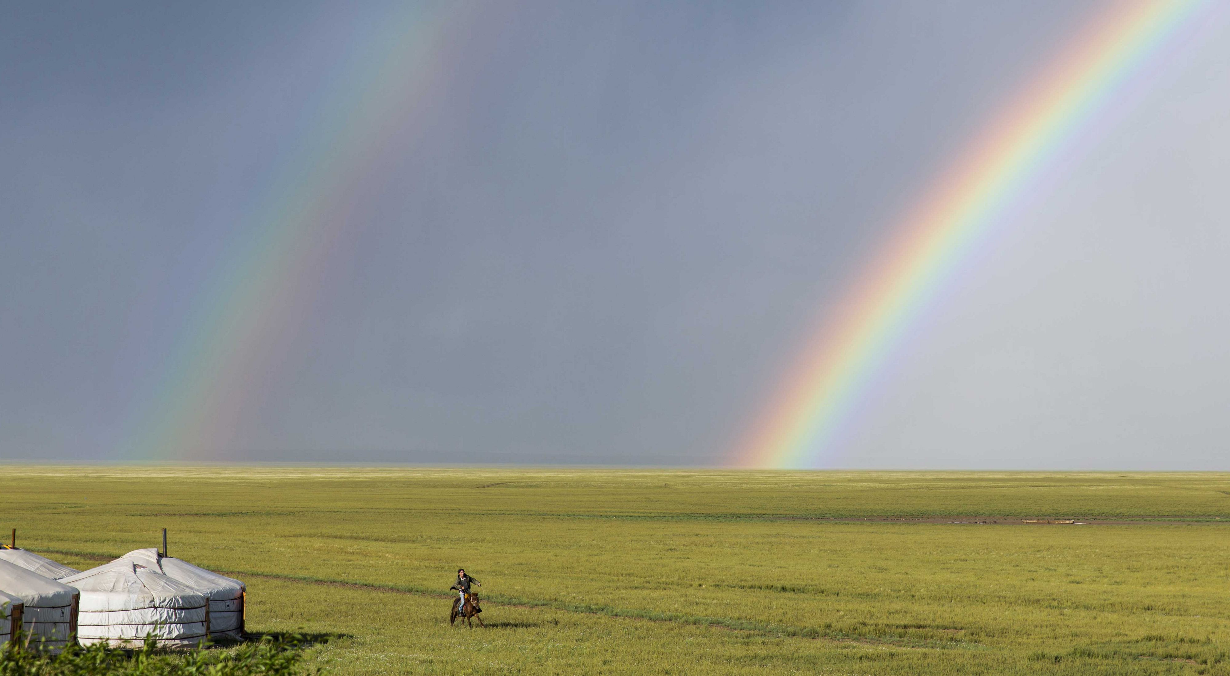past gers and a double rainbow in the South Gobi Desert, Mongolia.