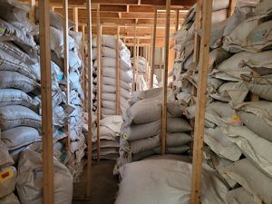 White bags piled up in a warehouse.