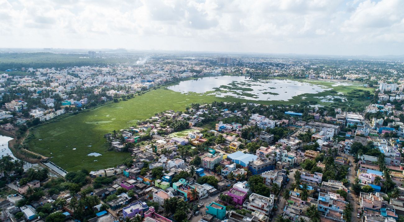 an aerial image of a city surrounding a lake park.