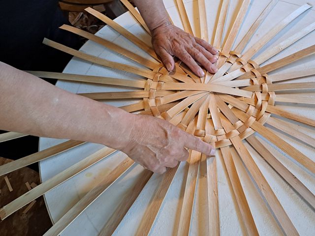 Richard Silliboy, vice chair of the Mi'kmaq Nation in present-day Maine, weaves a basket in his studio. Brown ash plays a central role in the Wabanaki creation story.