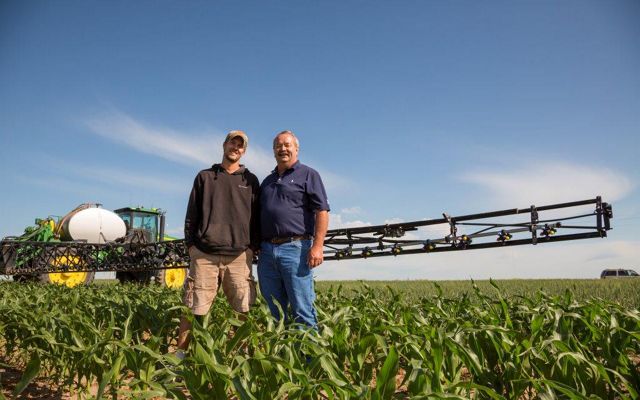 Roric Paulman and son in agricultural field in Nebraska.
