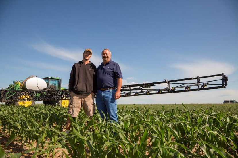 Roric Paulman and son in agricultural field in Nebraska.