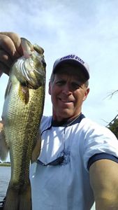 A selfie of a man holding a large fish.