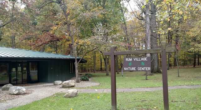 One-story nature center sits among trees in autumn. 