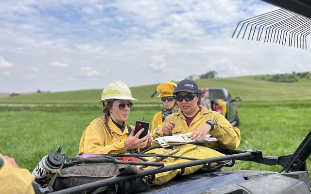 group of women going over burn plan.