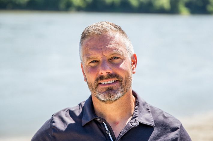 Close up photo of a man smiling.