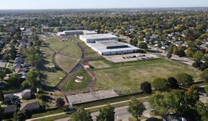 An aerial view of the same school, but with a large green schoolyard. 