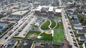 An overhead drone image of a schoolyard filled with greenspace.
