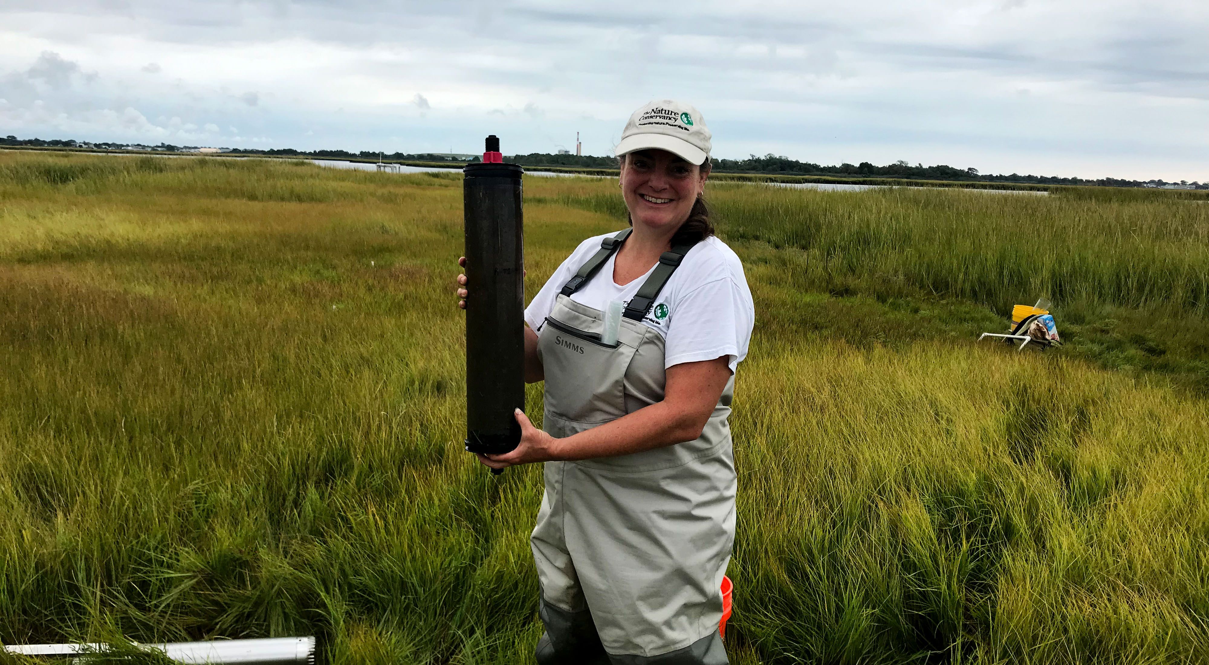 Nicole Maher poses with a salt marsh sample.
