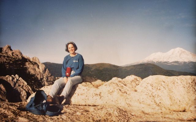Samantha Horn sitting at a rocky overlook.