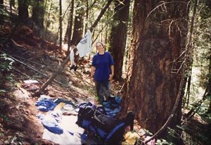 Samantha at a wooded campsite.