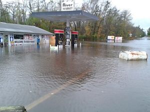 A view of a gas station flooded with several feet of water.