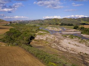 Eastern view of the Santa Clara River showing a wide expanse of land with the river meandering through it. 