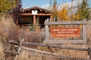 Old wooden fence with cabin in background.