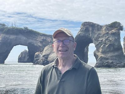 mike with the ocean and arches behind him.
