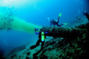 2 divers inspect the effects of Delray Beach sewage outfall on the coral reef in Florida. 