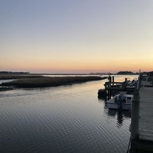 Sunset over the pier and water on an oyster farm.