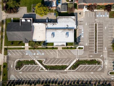 View from directly above showing a parking lot with more plantings between the rows of spots.