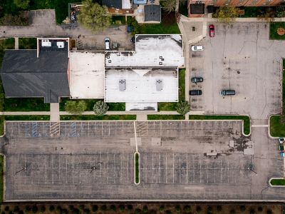 View from directly above showing a parking lot without plantings or trees.
