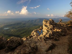 Man standing atop a mountain.