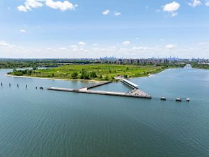 An aerial photograph features Shirley Chisholm State Park. 