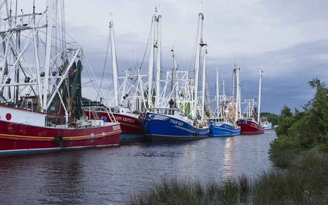 Colorful boats line up along a waterway.