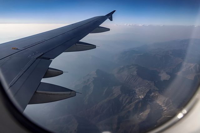 The wing of an airplane is viewed from inside of the aircraft.