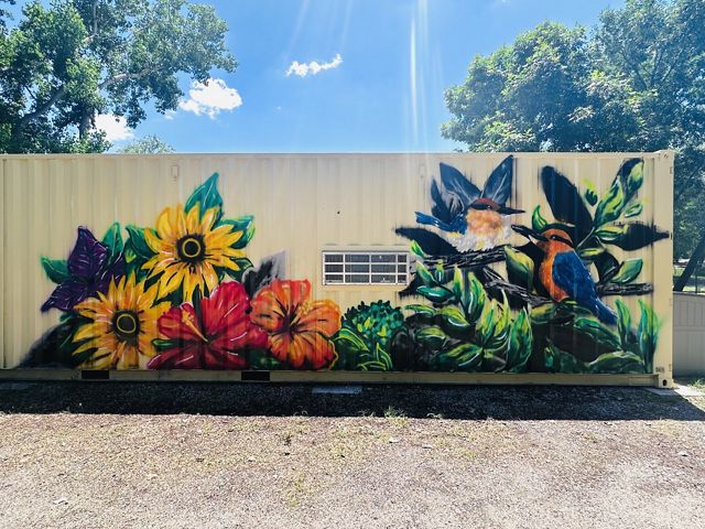 A sihek mural painted on the side of a building.