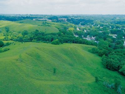 Aerial image of vibrant green grasses and trees of the 150-acre open prairie in Loess Hills.