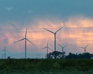 Wind turbines against a morning sky.