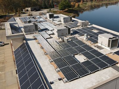 Looking down onto a roof that is covered in solar panels.