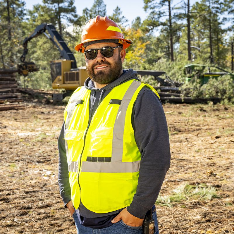 Devon Suarez wearing safety equipment in a forest