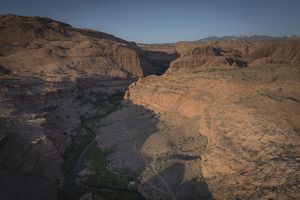 An aerial view of Mill Creek Canyon, featuring dramatic rock formations and the thin thread of the creek running through them.