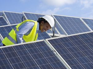  Electrical engineer woman checking solar photovoltaic panels on the roof of a solar farm.