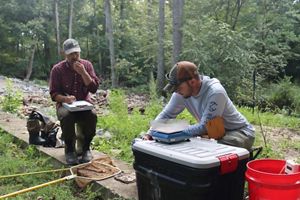 TNC staff members measure, weigh, and identify fish. 