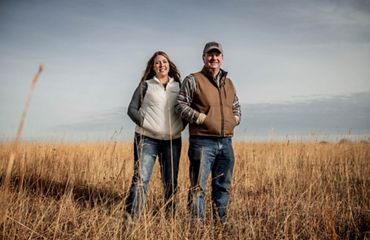 Heidi Mehl and Tod Bunting pose in a pasture.