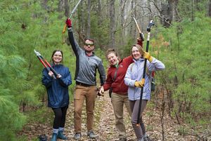 TNC Volunteers holding trail maintanence tools.